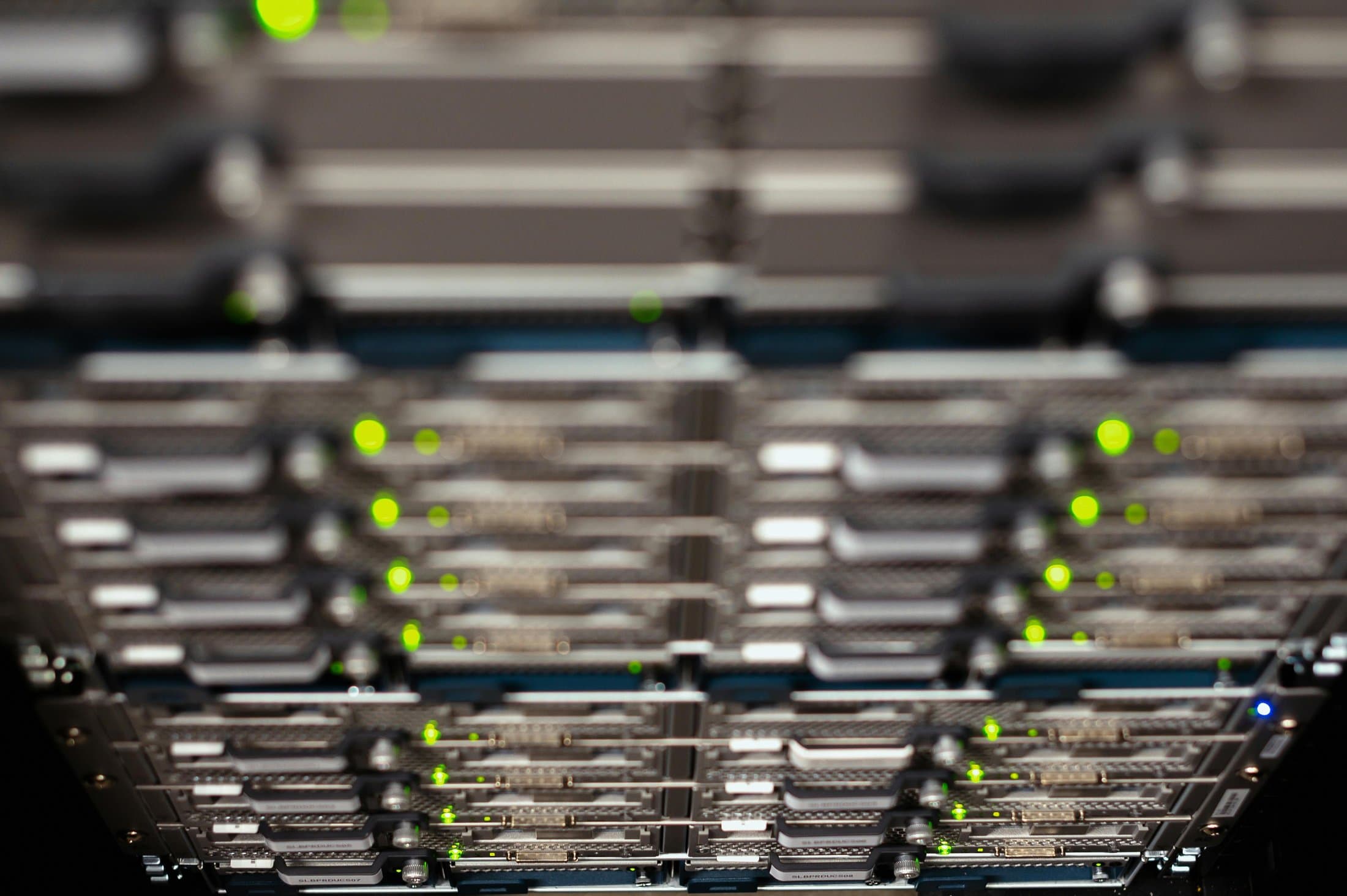 Rack de servidores con luces verdes — representa el sector de bienes y tecnología